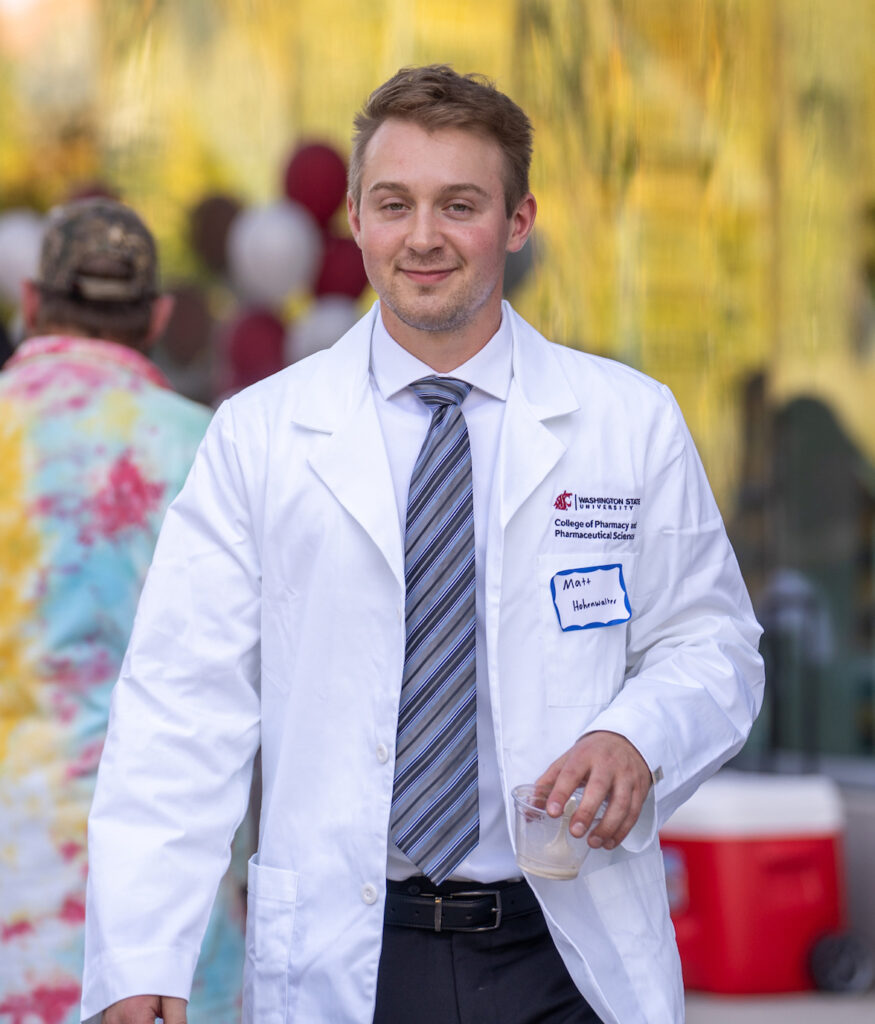 Someone wearing a neck tie and white coat from WSU College of Pharmacy and Pharmaceutical Sciences.