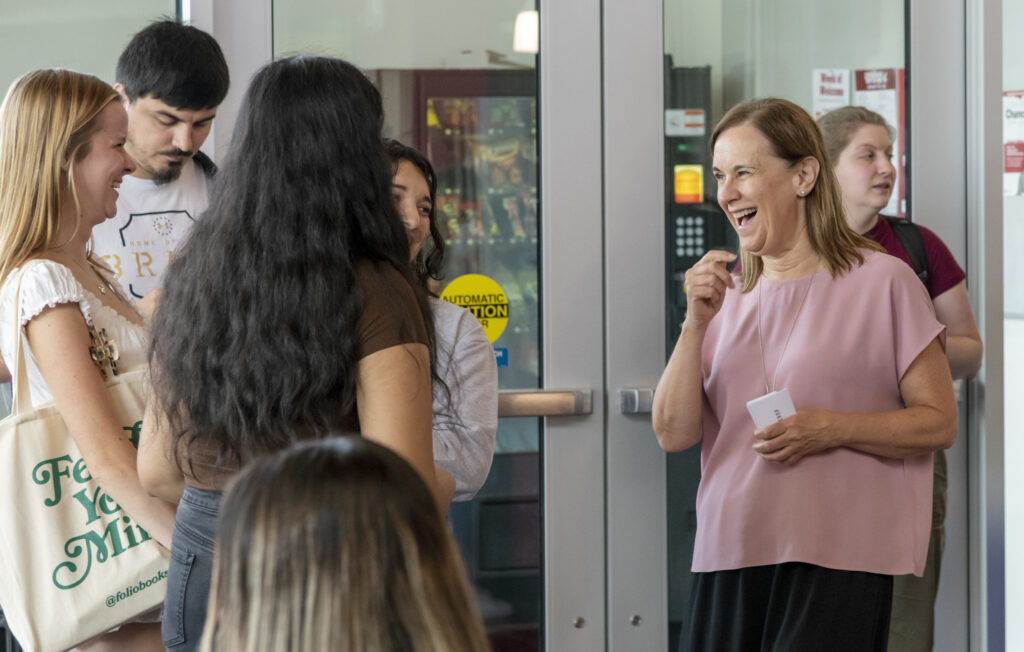 People sharing a laugh with WSU Tri-Cities Chancellor Sandra Haynes.