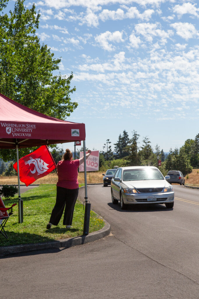 Employees welcome cars driving to the WSU Vancouver campus.
