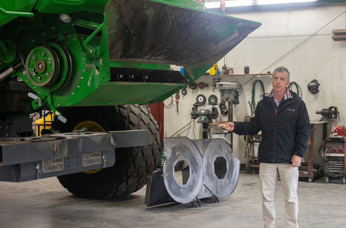 Closeup of Michael Walsh next to a combine.