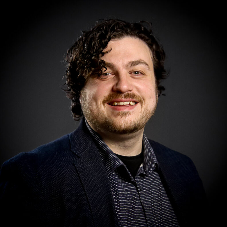 Profile photo of Stephen Pool wearing a button-up shirt and jacket. 