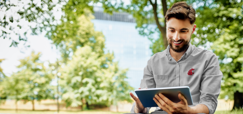 Man in WSU shirt on tablet