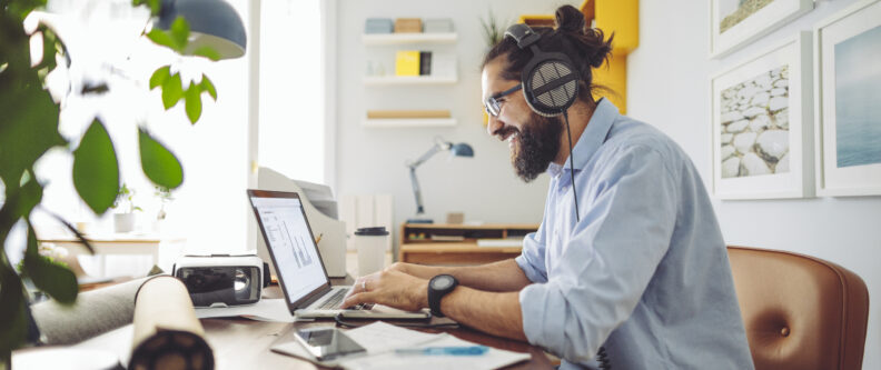 Man with heaset on laptop