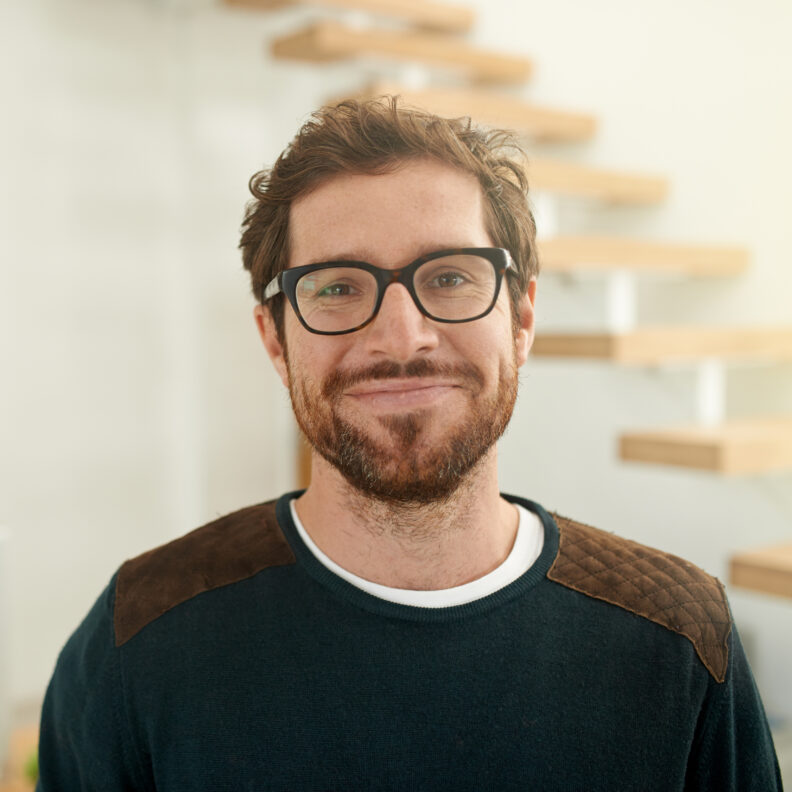 Man in glasses looking into camera