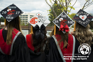 Four College of Nursing graduates standing in a line