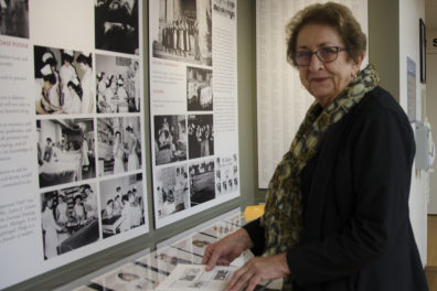 Janet Holloway stands in front of a display of nursing memorabilia at St. Luke's Rehabilitation Institute