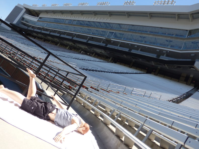 Photo of Sim Man mannequin laying in the stands at the football stadium in Pullman.