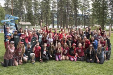 group shot with fists raised in Go Cougs! salute