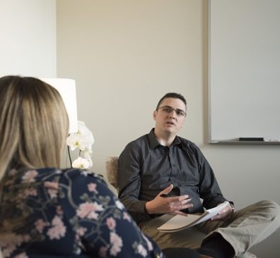 Andrew Colburn talks to a patient