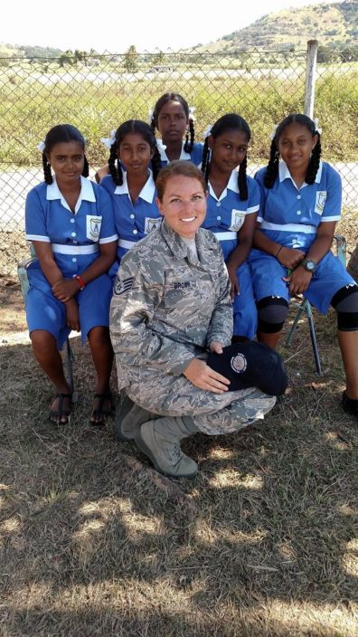 Angela Brown in camo with young girls in Fiji