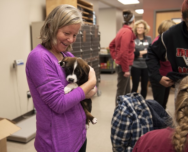 woman holding puppy