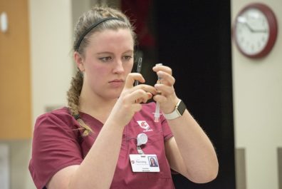 student preparing hypodermic needle