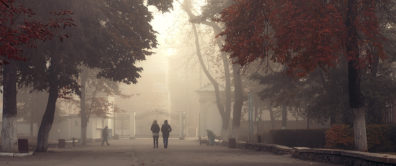 two people walking on a college campus during wildfire smoky season
