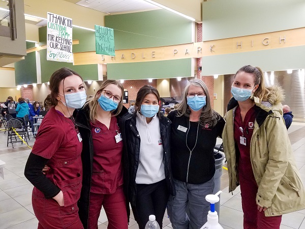 group of students and faculty at a vaccination clinic