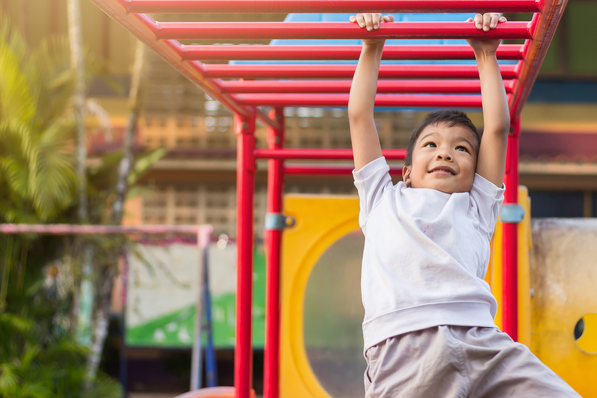 Kid on playing on monkey bars