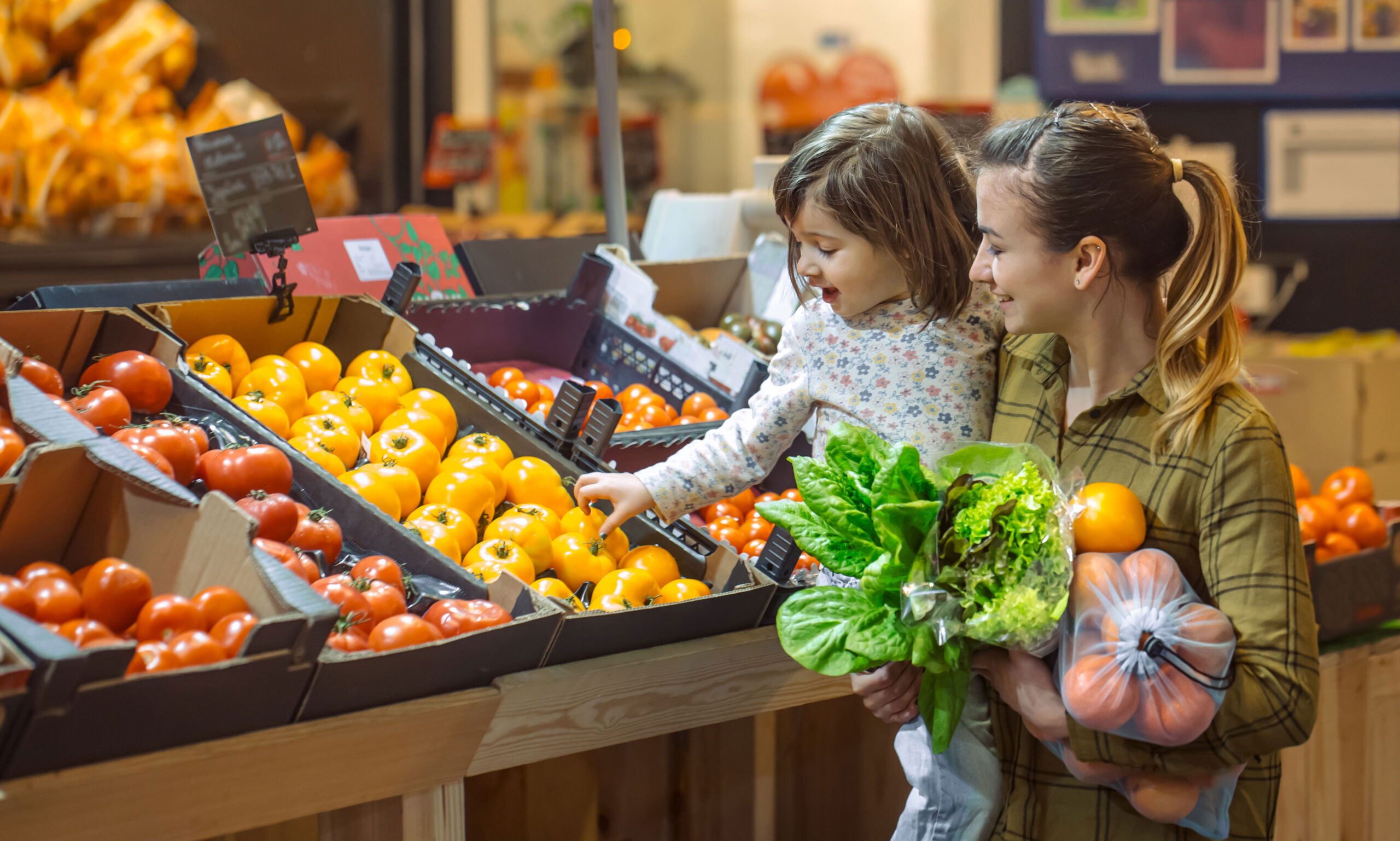 Mother and daughter shopping for vegetables