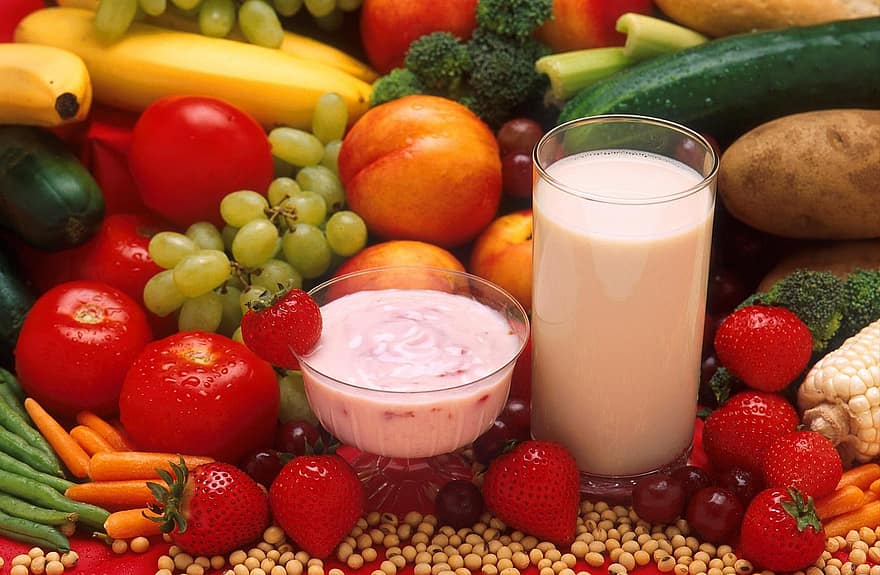 Vegetables and fruits around yogurt and milk.