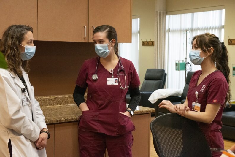 WSU nursing instructor and two students talk 