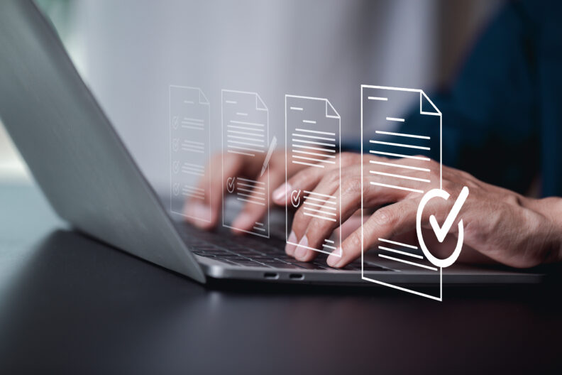 Close up photo of a person typing on a laptop. 