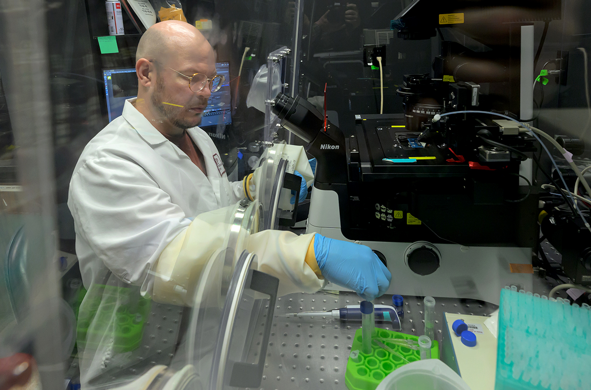Researcher using a microscope