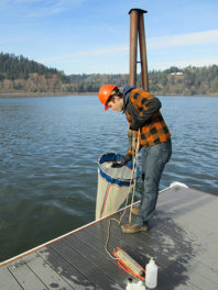 man on dock with long net.