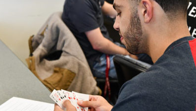 man holding playing cards