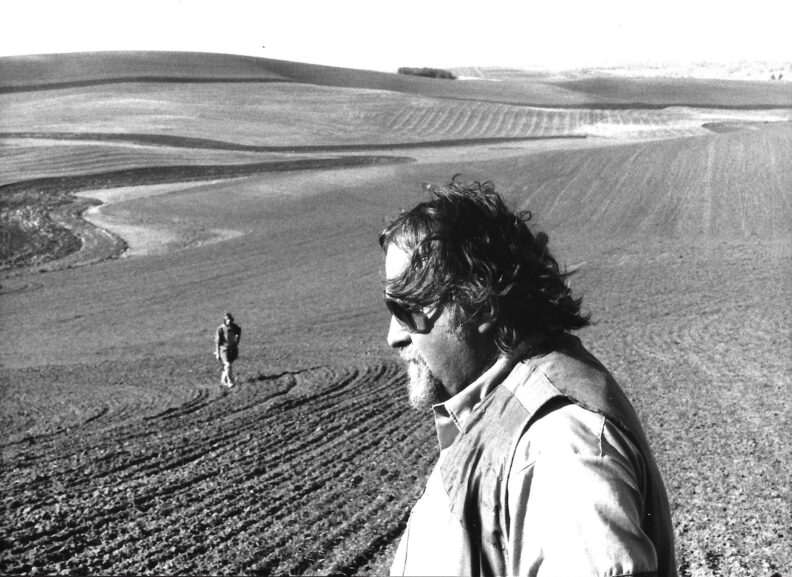 Black and white photo, Side profile of a man in a field.