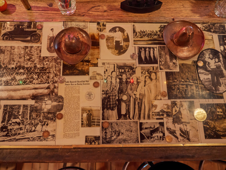 Photo of an art installation of a bar countertop with photos. 