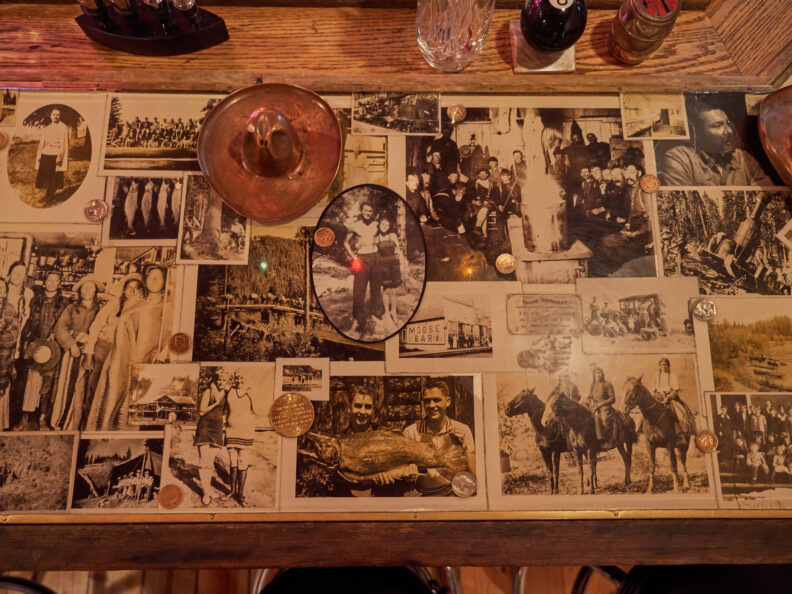 Photo of an art installation of a bar countertop with photos. 