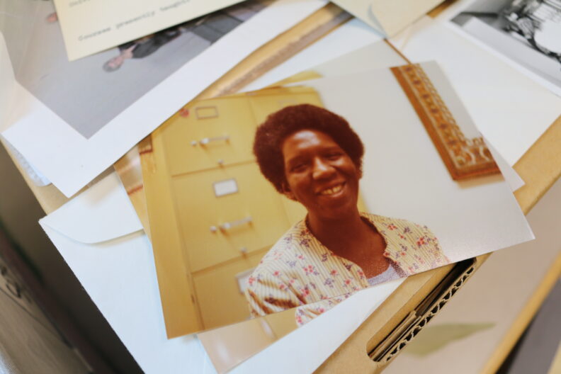 A picture of Gladys Kidd Jennings on top of a box with other photos strewn about on top.