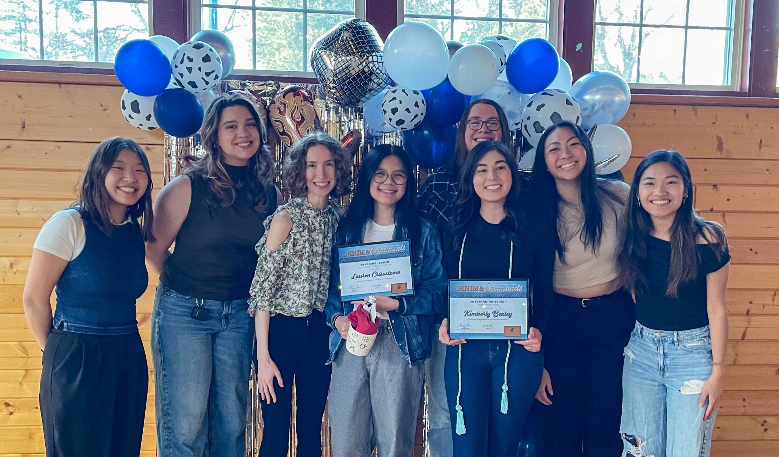 A group of Food Science students grouped together. Two of them hold up their awards.