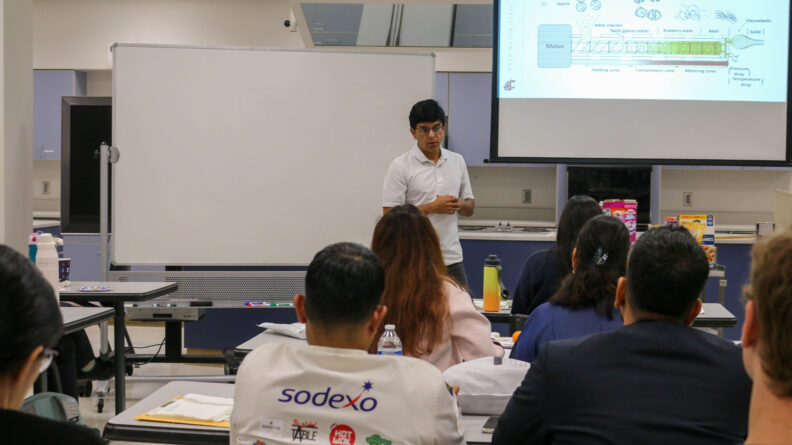 Dr. Girish Ganjyal speaks in front of a group of people.