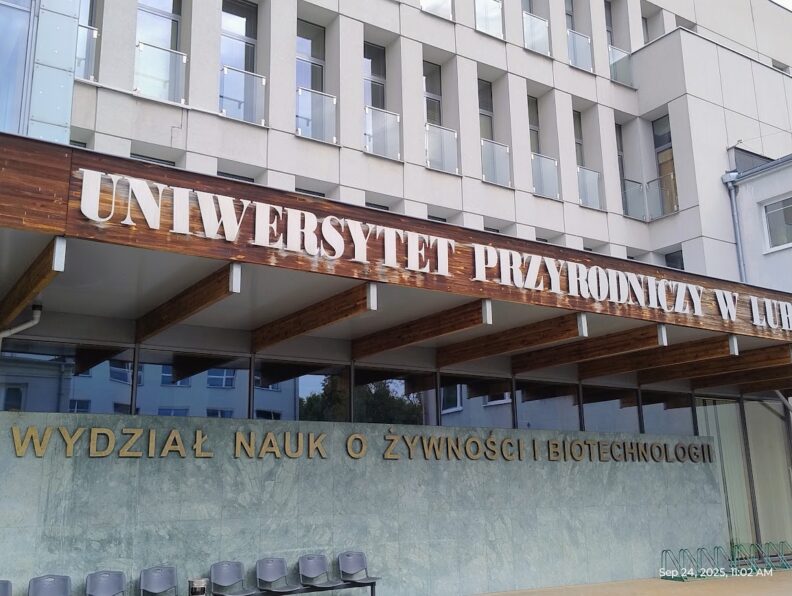 The university building that hosted the conference. There is a sign written in Polish.