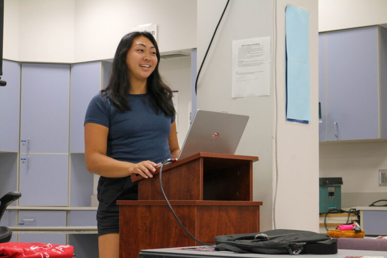 Natalie talks at a podium.