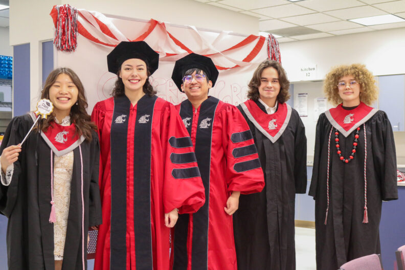 All of our graduates, both undergrad and grad, stand together.
