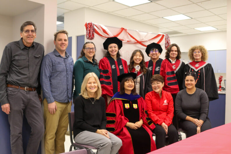 Staff, Faculty, Deans, and the graduating class stand in two rows.