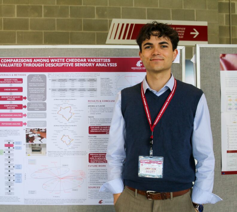 Jayden stands proudly in front of his research poster.
