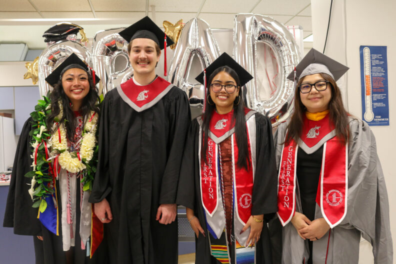 Our three graduating undergrads and a graduating masters student stand together.