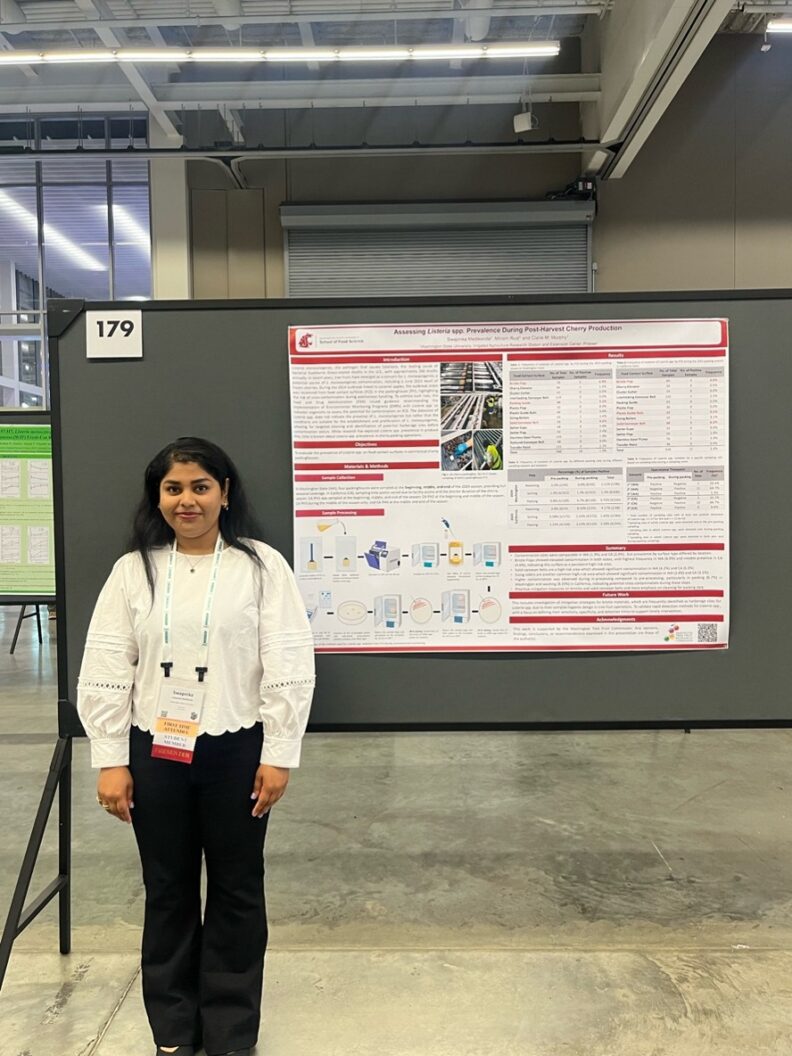 Swapnika stands next to her research poster.