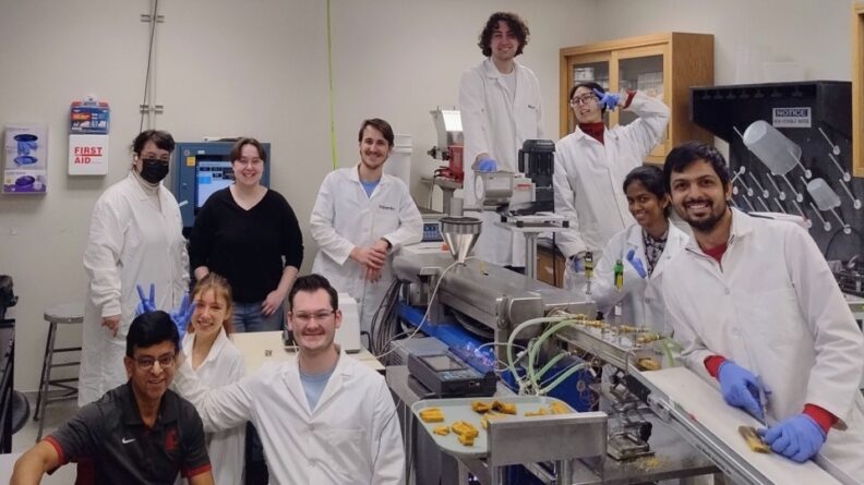 The Ganjyal lab posing around the extrusion machine.