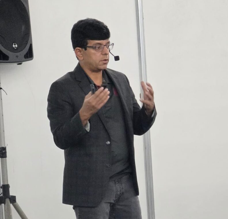 Girish talks with his hands as he talks during his presentation.