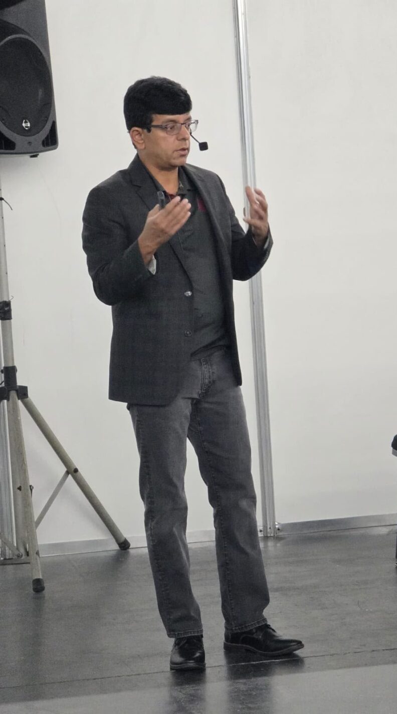 Girish talks with his hands as he talks during his presentation.