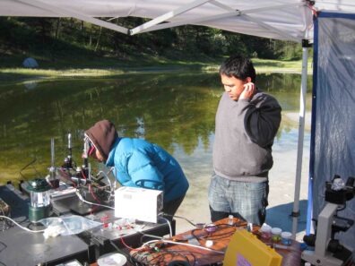 People standing outside next to lab equipment.