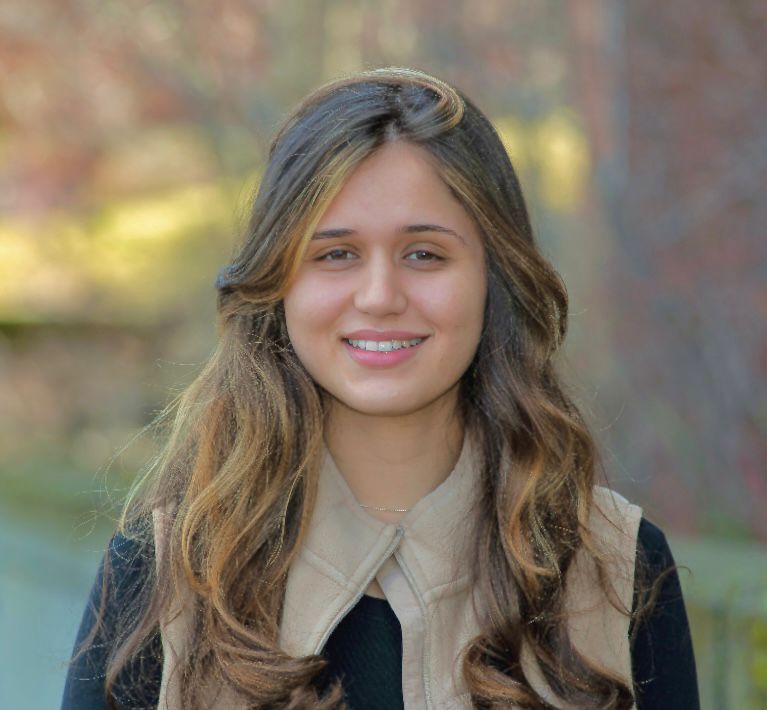 Maria outside, she's wearing black and tan.