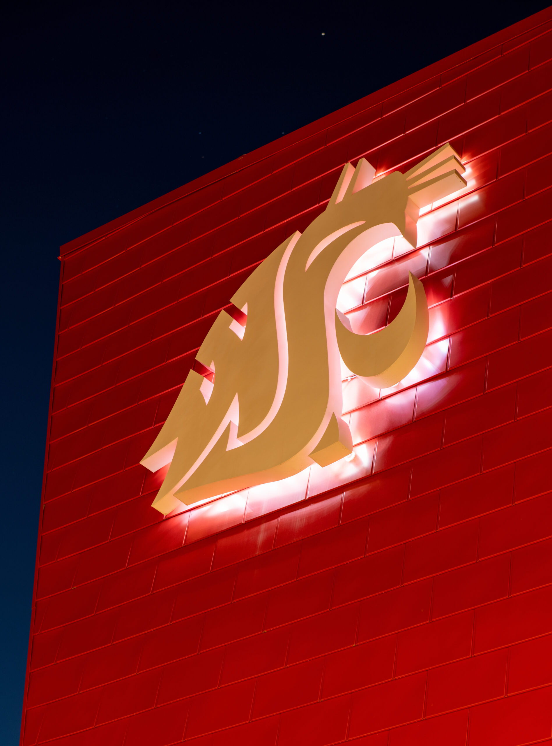 The WSU cougar head logo on the side of a building.