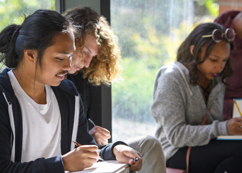 Students taking notes in a classroom