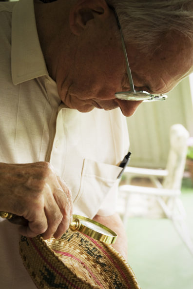 Archaeologist Richard Daugherty looks at a Makah basket in 2007.  Photo by Zach Mazur