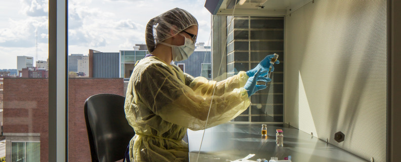 Researcher working under hood