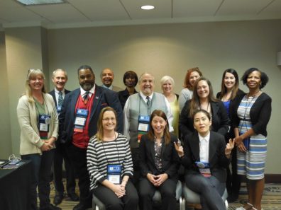 Professor Faith Lutze with about a dozen other ACJS members.