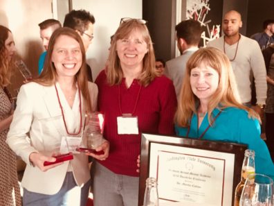 Elizabeth Drake holds her award as she smiles with Dr. Faith Lutze and Dr. Martha Cottam.